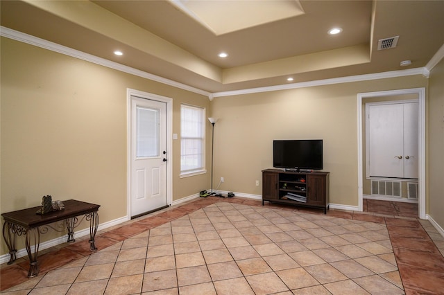 foyer featuring a raised ceiling, light tile patterned floors, and visible vents