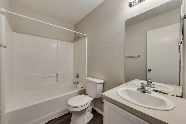 bathroom with bathing tub / shower combination, toilet, wood finished floors, and vanity