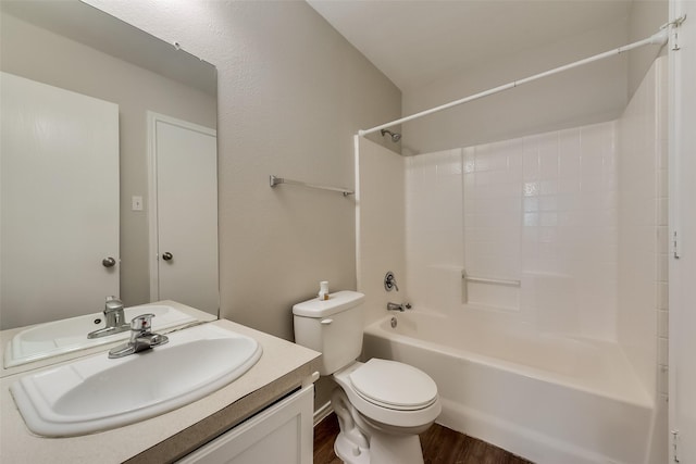 bathroom featuring shower / bathtub combination, toilet, vanity, and wood finished floors