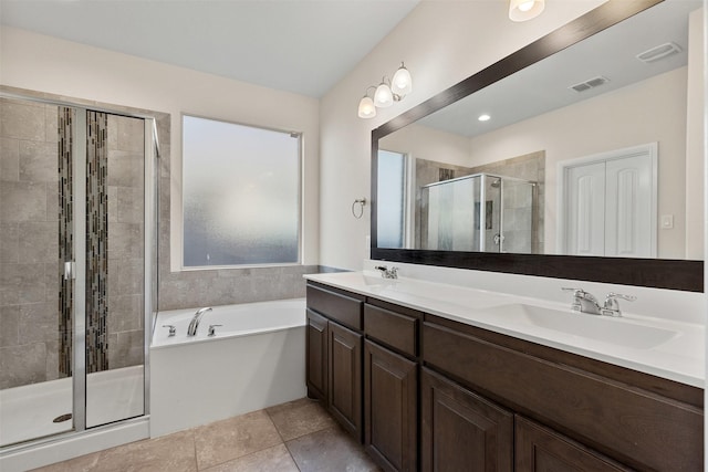 bathroom featuring visible vents, a sink, a shower stall, double vanity, and a bath