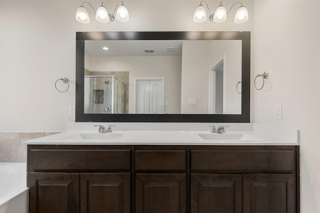 full bath with double vanity, a stall shower, a garden tub, and a sink