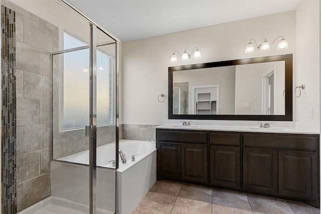 bathroom with a sink, double vanity, a bath, and a shower stall