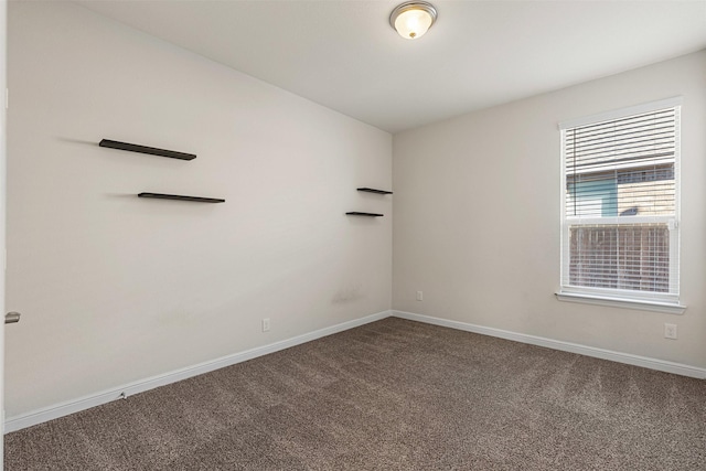 carpeted empty room with baseboards