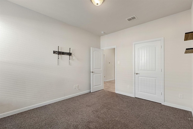 unfurnished bedroom featuring baseboards, visible vents, and carpet floors