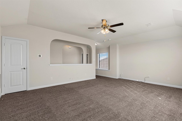 spare room with visible vents, carpet flooring, ceiling fan, and vaulted ceiling