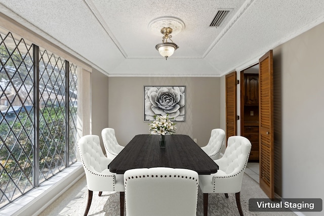 dining room featuring visible vents, a raised ceiling, a textured ceiling, and carpet floors