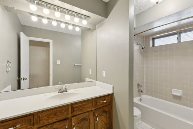 full bathroom featuring vanity, toilet,  shower combination, and tile patterned flooring