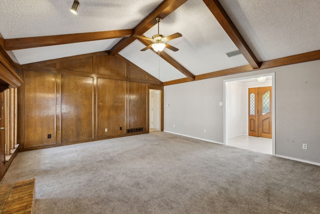 unfurnished living room featuring visible vents, a textured ceiling, light colored carpet, ceiling fan, and vaulted ceiling with beams