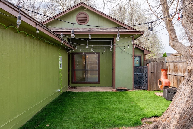 back of house with a lawn, central AC, and fence