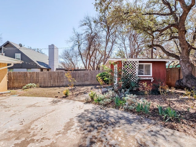 view of yard with an outdoor structure and fence private yard