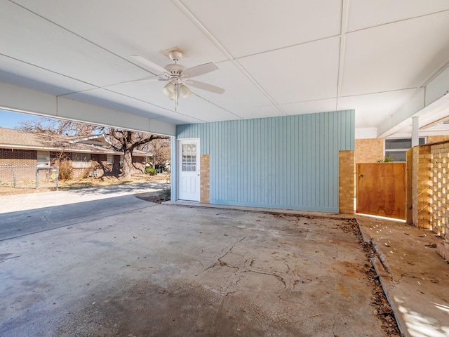 garage with ceiling fan and fence