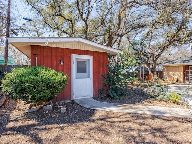 view of outbuilding featuring an outbuilding and fence