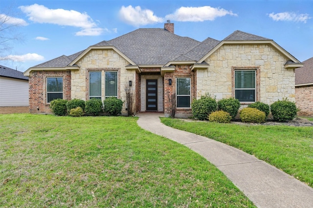 7727 Indian Ridge Trl, Dallas, TX 75232 - view of front of house featuring stone siding, a front yard, and roof with shingles