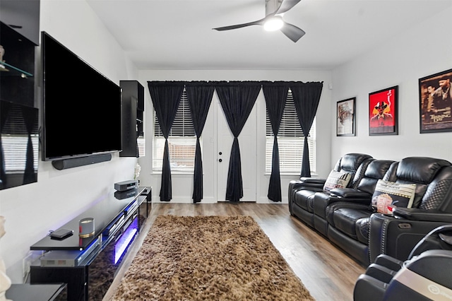 living area with ceiling fan and wood finished floors