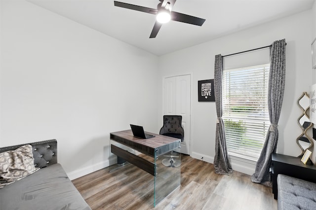 office with baseboards, wood finished floors, and ceiling fan