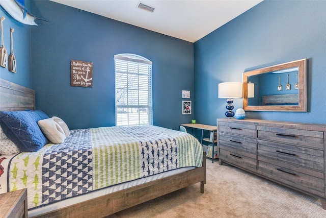 carpeted bedroom featuring visible vents