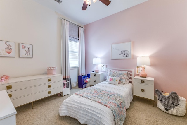 bedroom with visible vents, light colored carpet, and ceiling fan