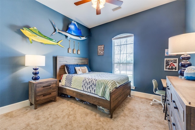 bedroom featuring visible vents, light carpet, baseboards, and a ceiling fan