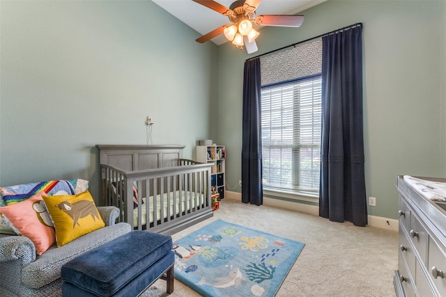 bedroom with a ceiling fan, light colored carpet, and baseboards