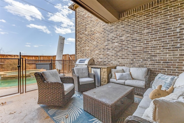 view of patio with area for grilling, an outdoor hangout area, an in ground hot tub, and fence