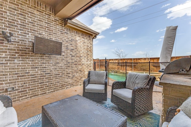 view of patio with an outdoor kitchen and a fenced backyard