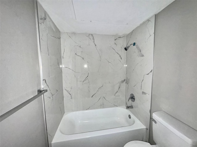 bathroom with bathtub / shower combination and toilet