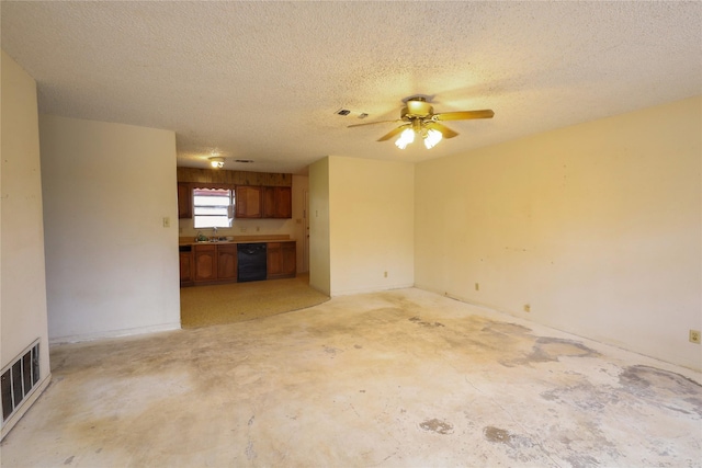 unfurnished living room with visible vents, concrete flooring, a textured ceiling, a ceiling fan, and a sink