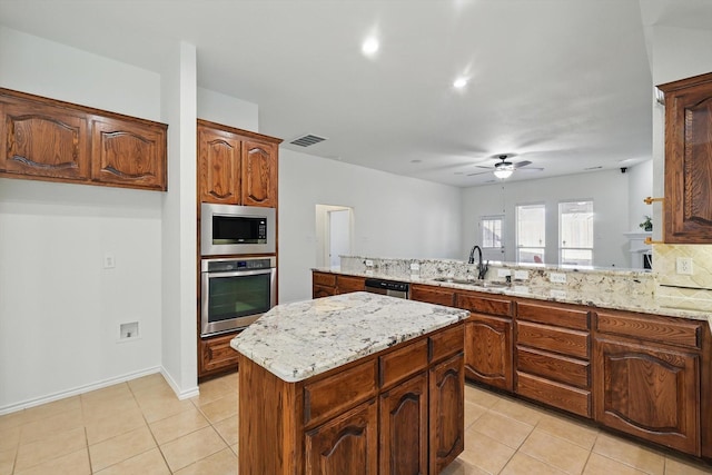 kitchen featuring light tile patterned floors, visible vents, a sink, ceiling fan, and stainless steel appliances