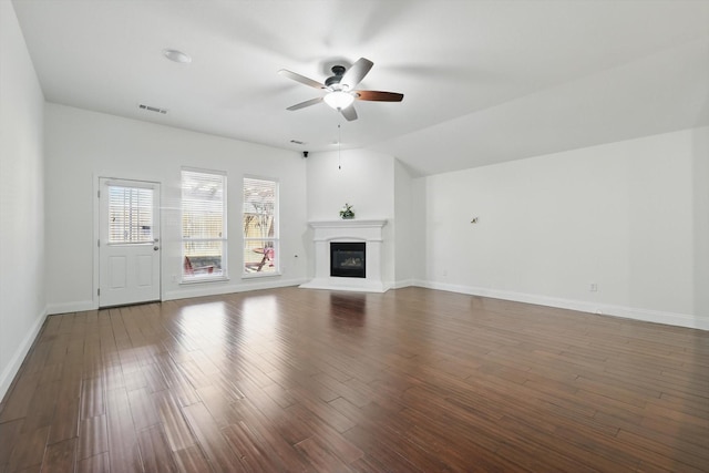 unfurnished living room featuring visible vents, a ceiling fan, wood finished floors, baseboards, and lofted ceiling