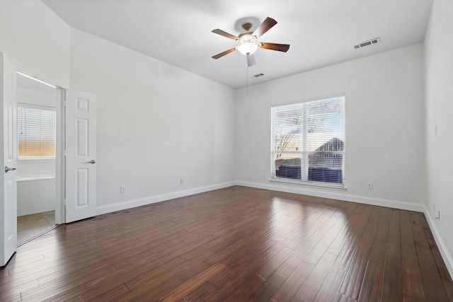 unfurnished room with dark wood-type flooring, a ceiling fan, and visible vents