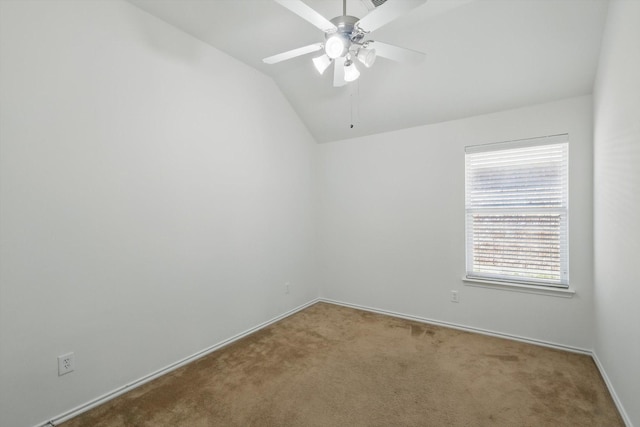 spare room with ceiling fan, baseboards, carpet, and lofted ceiling