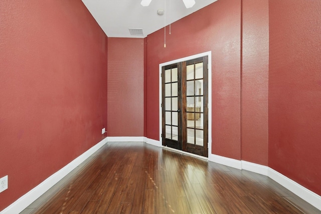 unfurnished room with visible vents, a ceiling fan, french doors, wood-type flooring, and baseboards