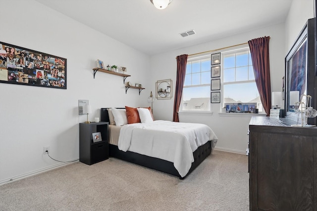 bedroom featuring visible vents, baseboards, and carpet