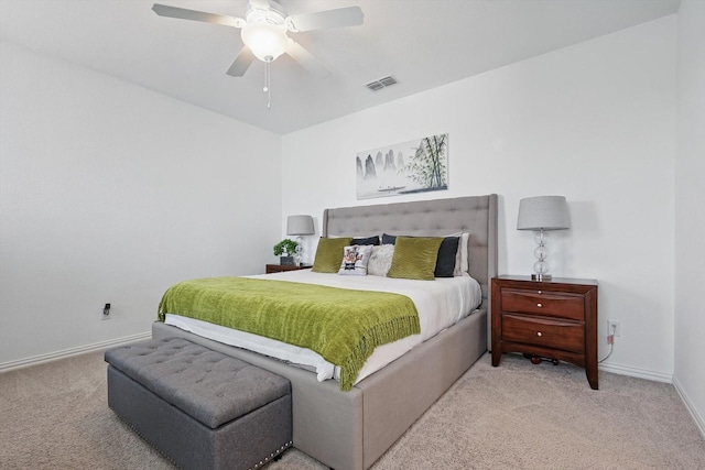 carpeted bedroom featuring a ceiling fan, baseboards, and visible vents