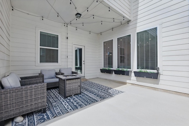 view of patio featuring an outdoor living space with a fire pit