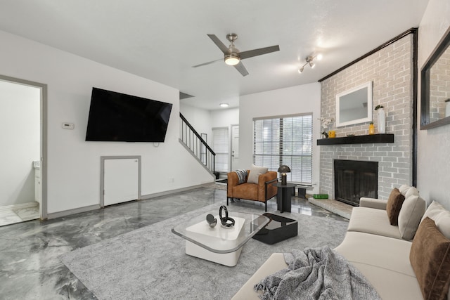 living room with stairway, marble finish floor, a brick fireplace, and baseboards