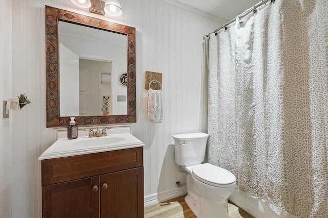 full bath featuring baseboards, toilet, wood finished floors, and vanity