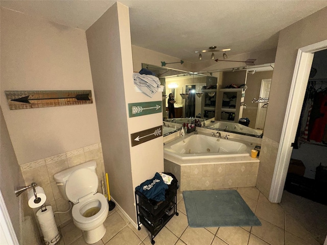 full bath featuring tile patterned flooring, toilet, and a whirlpool tub