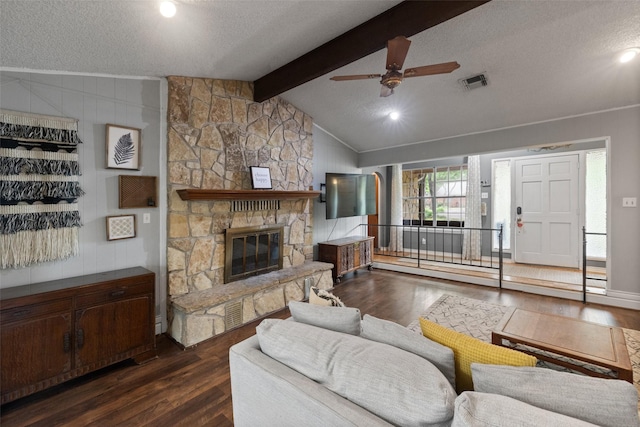 living room featuring visible vents, vaulted ceiling with beams, dark wood finished floors, a textured ceiling, and a ceiling fan