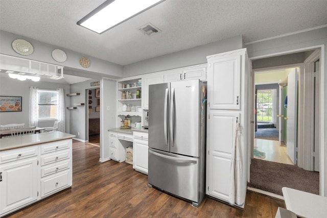 kitchen featuring visible vents, open shelves, dark wood-style floors, freestanding refrigerator, and white cabinets