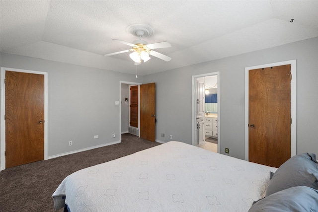 bedroom featuring carpet flooring, baseboards, connected bathroom, and a textured ceiling