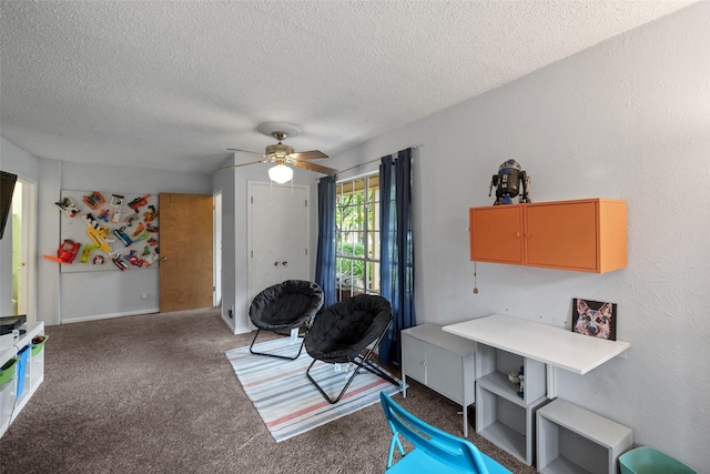 living area featuring a textured ceiling, carpet, a ceiling fan, and a textured wall