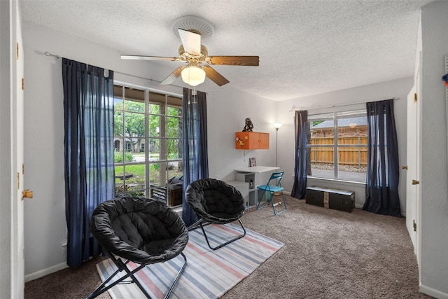 sitting room featuring plenty of natural light, carpet, and ceiling fan