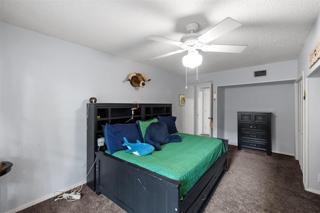 bedroom with baseboards, carpet floors, and a textured ceiling