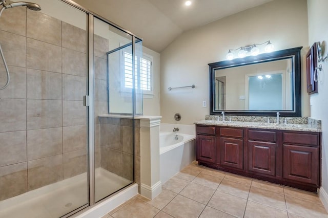 bathroom featuring double vanity, a stall shower, a sink, tile patterned floors, and a bath