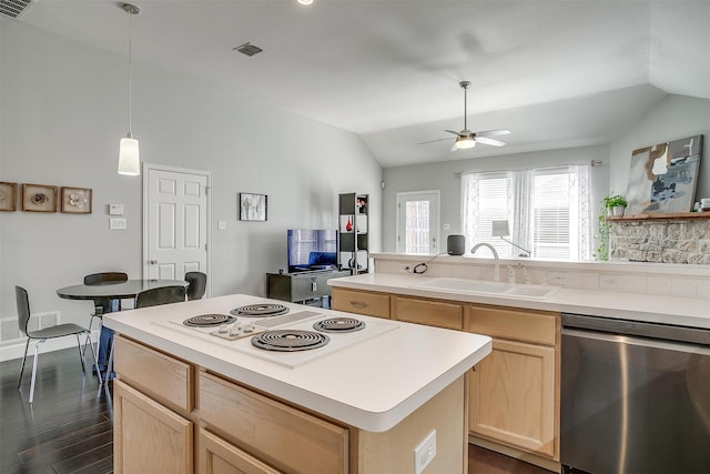 kitchen with light brown cabinets, lofted ceiling, stainless steel dishwasher, white electric stovetop, and a sink