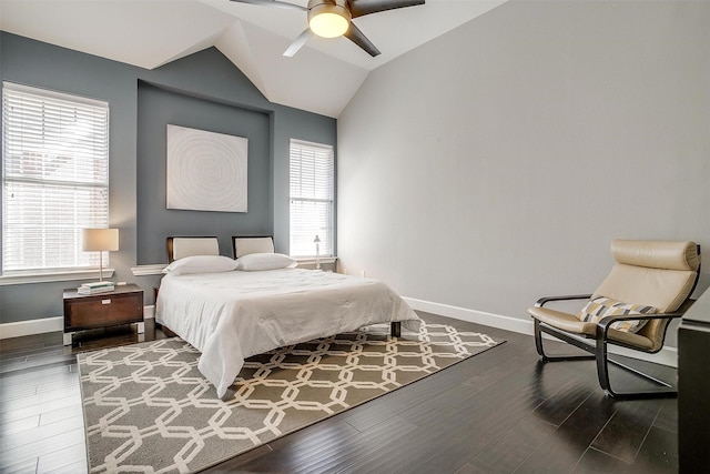 bedroom with baseboards, lofted ceiling, dark wood-style floors, and a ceiling fan