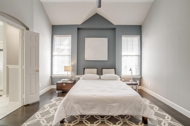 bedroom featuring baseboards, lofted ceiling, and dark wood finished floors