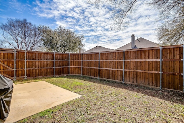 view of yard featuring a patio area and a fenced backyard