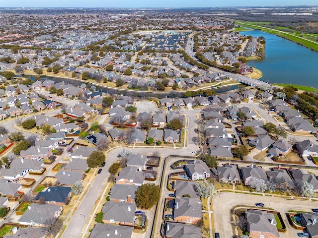 drone / aerial view featuring a residential view and a water view